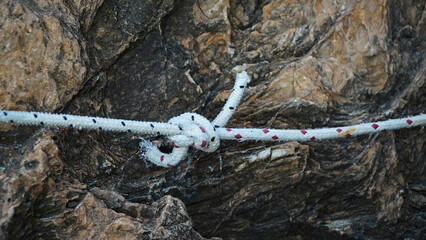 tying a boat with a rope. the boat moored at the shore.