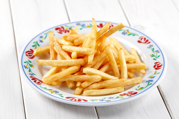 golden french fries on the wooden background