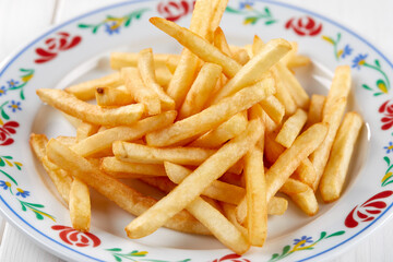 golden french fries on the wooden background
