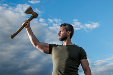 confident man with axe. caucasian man hold ax. brutal man showing power on sky background