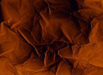 Creased paper texture. Grunge overlay. Distressed photo editor mask. Orange black crumpled wrinkled noise on dark illustration abstract background.