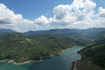 aerial shot lake and mountains, white clouds