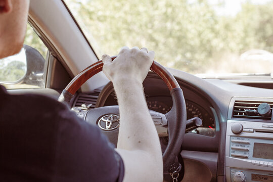 A Man Driving A Toyota, View From The Passenger Compartment. Safe Driving