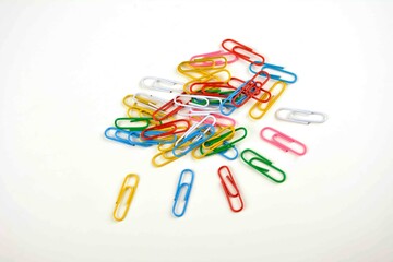 Colored paper clips on a white background.
