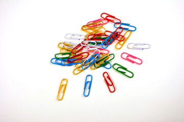 Colored paper clips on a white background.