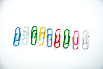 Colored paper clips on a white background.