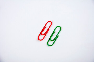 Colored paper clips on a white background.