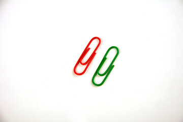 Colored paper clips on a white background.