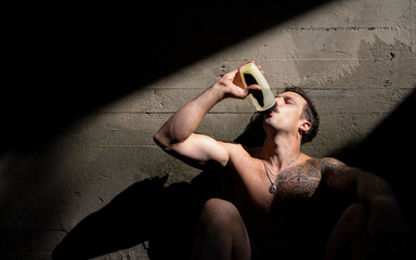 A man is drinking water after a hard workout.