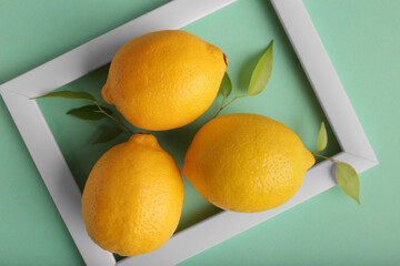White frame and lemon on green background