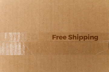 Detail of a cardboard box written on free shipping. Delivery box. cardboard box concept. black friday concept