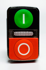 Small starter with a red and green buttons on a white background. Red and green push buttons for starting your motor. Green indicator. Selective focus. Background picture.