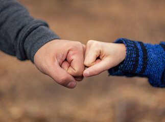 Father and son fist bump.