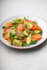 Salmon salad with avocado,  for keto and low carb diet. Rusty background, top view, copy space.