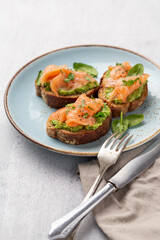 Salmon avocado keto sandwiches on healthy seed buns.