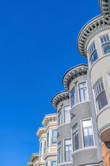 Fototapeta na wymiar Victorian townhouses with decorative frieze and dentils in a low angle view at San Francisco, CA