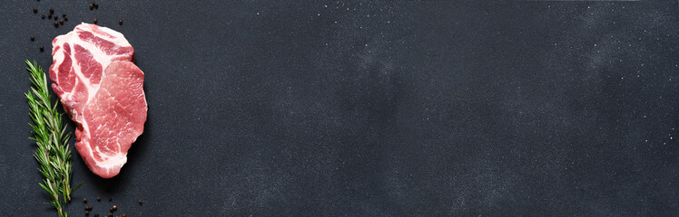 Raw meat steak and raspberry on concrete background. Pork. Rebay beef. With space for text