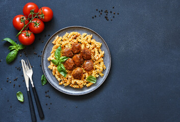 Italian pasta with meatballs, tomato sauce and spices, top view, with space for text