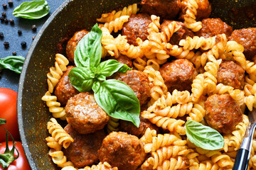 Italian pasta with meatballs, tomato sauce and spices, top view, with space for text