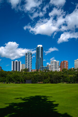 Fototapeta na wymiar Edmonton cityscape with dramatic clouds over Victoria Park's green in the Province of Alberta, Canada