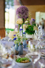 beautiful setting of a large table with snacks and flowers. 