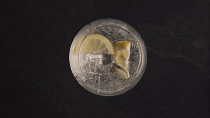 Hands throw mint into lemon ice drink closeup. Making summer cocktail concept