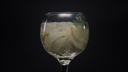 Fizzy lemon ice mint bubbled cocktail closeup. Summer fresh cold drinks concept