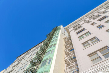 Low angle view of multi-storey residential buildings with emergency stairs at San Francisco, CA