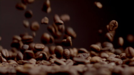 Closeup coffee beans fall on heap. Brown fresh seeds pouring super slow motion