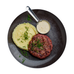 beef steak, beef patty with mashed potatoes and pepper sauce on dark plate isolated on white background top view