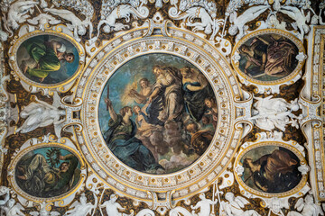 Old fresco paintings with a religious theme and realistic figures.
