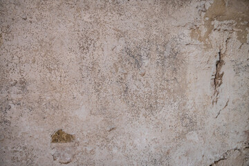 Background image of an old stucco wall that is very well aged and weathered.