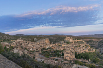 Fototapeta na wymiar Pink sunset overlooking the medieval village of Alquezar which is located in the province of Huesca (Spain). Alquezar is one of the most beautiful medieval villages in Spain. 