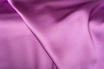 Lavender purple shiny folded satin fabric texture bg