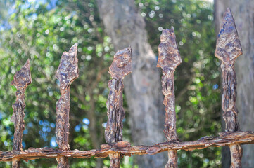 Close up of rusty sharp iron gate. Iron gate rusted by sea air