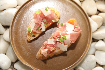 Italian bruschetta and prosciutto on table close up