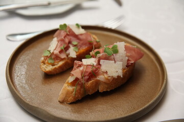Italian bruschetta and prosciutto on table close up