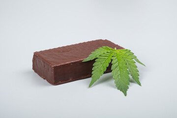 chocolate candy and cannabis leaf, thc sweets drugs.