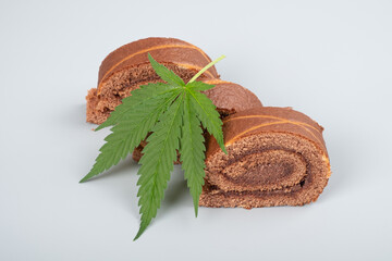 sweet roll cake with cannabis hash oil and green leaf.