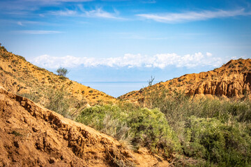 Fairytale canyon, Kyrgyzstan, Silk Road, Central Asia, red rocks, colourful, Yssykkul lake in background
