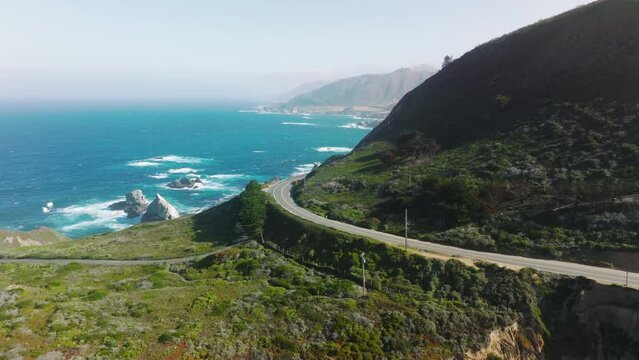 Aerial view of California's first scenic highway with romantic natural environment. Bright fresh green on the hills, washed with blues ocean waters. High quality 4k footage