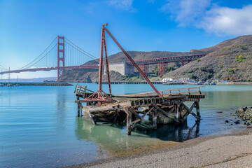 Wrecked wooden dock on the coast near the Golden Gate Bridge in San Francisco, CA