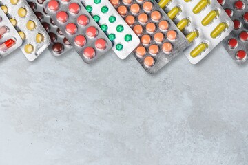 White blister tablets on pastel background