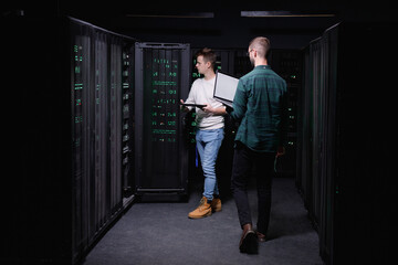 IT employee concentrating at work with diagnostic of computer hardware