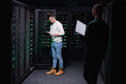 Computer experts working in team to repairing DBMS networking 