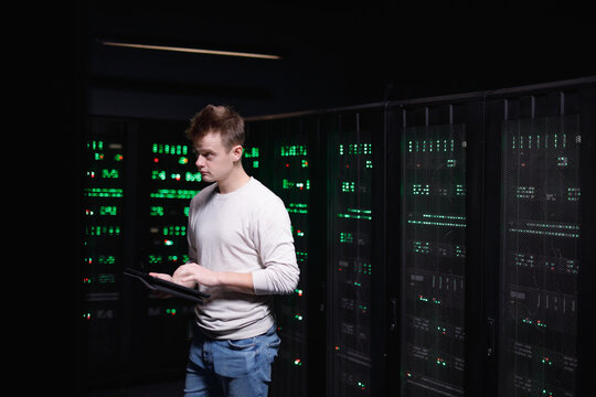 Worker assessing consequences of breakage of servers 