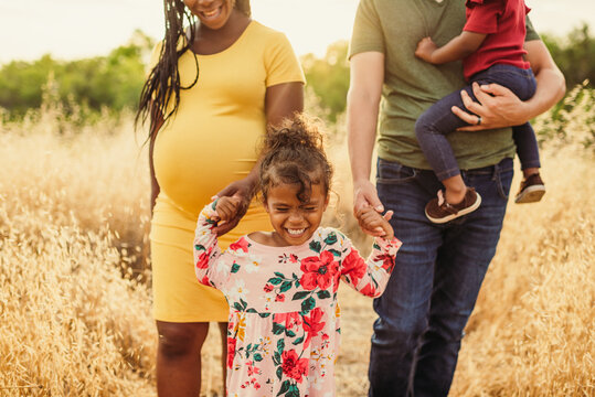 Girl Holding Hands with Family