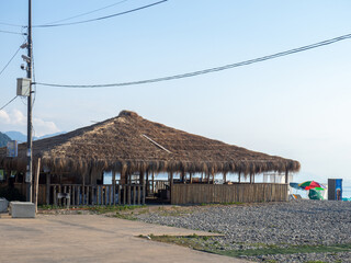 Thatched roof restaurant. Vacation at the resort. Nice secluded place. Roof of dried leaves.  Rest on the sea