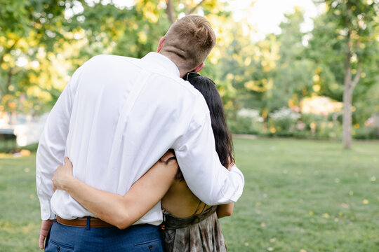 Groom Hugging Guest at Wedding