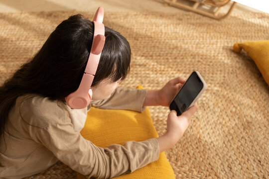 Relaxed girl using smartphone at home